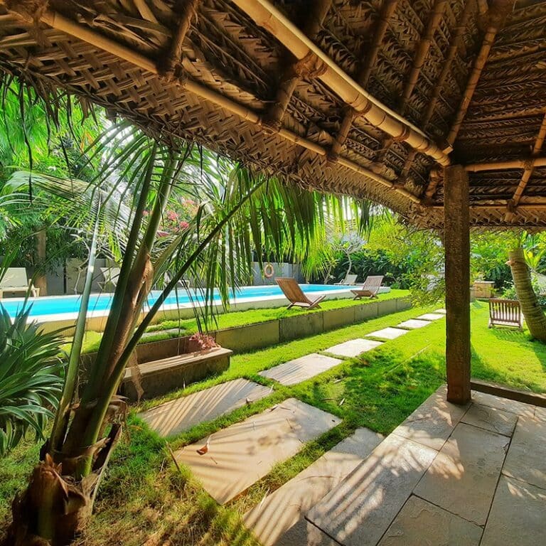 swimming pool in the tropical garden of the heritage mansion converted in luxury hotel